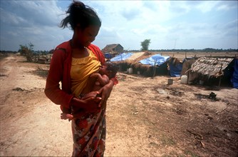 CAMBODIA, Kompong Thom, "Phnom Prasat Khmer Rouge refugee camp.  Young woman breast feeding her