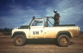 CAMBODIA, Thmar Pouk, Dutch made UN jeep with a soldier standing behind a mounted rifle in the back