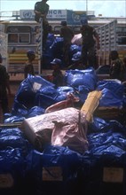 CAMBODIA, Battambang, UN troops unloading new arrivals baggage at a repatriation camp.