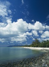 MALAYSIA, Langkawi, Kedah, Pantai Cenang beach looking towards Gunung Mat Cincang with a stoney