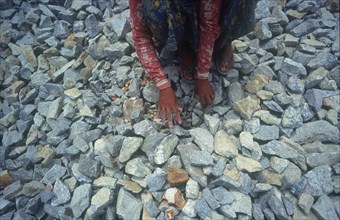 MYANMAR, Yangon, "Student forced labour working on the road to the War Cemetery.  Girl crouched to