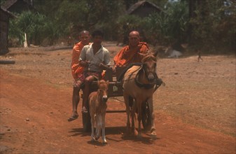CAMBODIA, Religion, Monks on a horse drawn cart on National Route 6 to Kompong Thom.