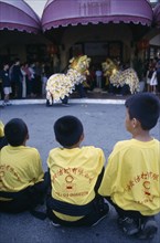 MALAYSIA, Kedah, Langkawi, Chinese New Year Dragon Dance with three children from the troupe in the