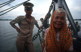 CAMBODIA, Neak Long, "Passengers on the Mekong ferry, old woman and soldier. "