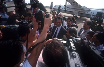 CAMBODIA, Phnom Pehn, A crowd of press photographers surrounding Sonn Sen as he arrives at the