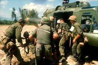 VIETNAM, War, "Marine dust off North of Tam Ky, wounded soldier being lifted into helicopter."