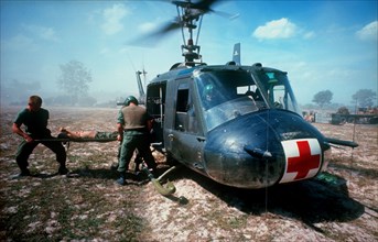 VIETNAM, Ba Cat, "Dust off operation, wounded soldier on a stretcher being lifted into helicopter