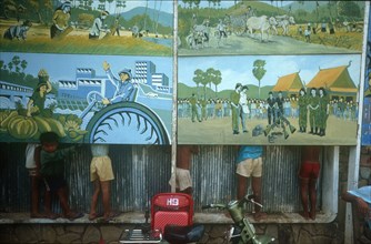 CAMBODIA, Phnom Pehn, Anti Khmer Rouge posters with line of children behind so only their legs can