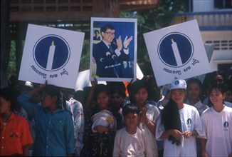 CAMBODIA, Politics, Crowd waving election campaign posters.