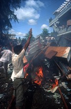 CAMBODIA, Phnom Pehn, Anti Khmer Rouge and Samphon demonstration.  Protestors burning debris.