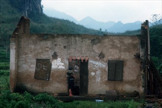 VIETNAM, Lang Son Province, Dong Dang, "Women holding a child, standing in the doorway of the