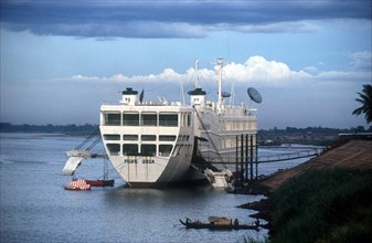 CAMBODIA, Phnom Pehn, Former Japanese car ship now the New Hotel on the Tonle Sap River.