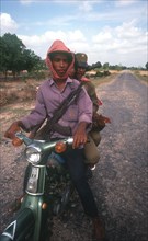 CAMBODIA, Kompong Thom, Motorbike army patrol on National Route 6.