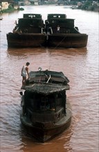 VIETNAM, Transport, Two barges pulling a boat upriver.