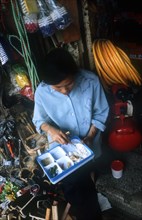 VIETNAM, Ho Chi Minh City, Looking down on a young woman eating from a plastic tray of different