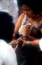 CAMBODIA, Tanko, Woman holding a child receiving ICRC innoculation.