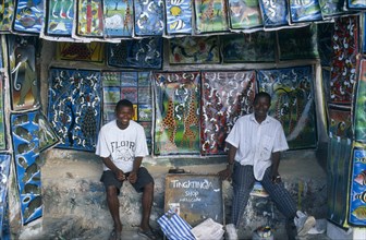 TANZANIA, Zanzibar Island, Arts and Crafts, Two young men in open fronted shop selling  paintings