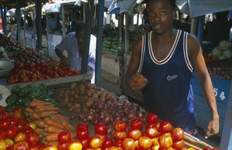 TANZANIA, Zanzibar Island, Zanzibar, Vegetable stall and vendor in local market.