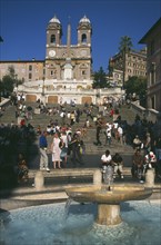 ITALY, Lazio, Rome, Piazza di Spagna.  Fountain in the foreground with people on the Spanish Steps