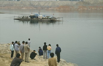 CHINA, Gansu Province, Yellow River, Linjiaxia Reservoir  with people waiting for the ferry