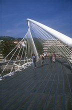 SPAIN, Basque Provinces, Vizcaya Province, Bilbao.  The Zubuzuri footbridge with people crossing.