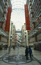 CHINA, Guangdong Province, Guangzhou, Multi level shopping centre interior with domed glass roof.