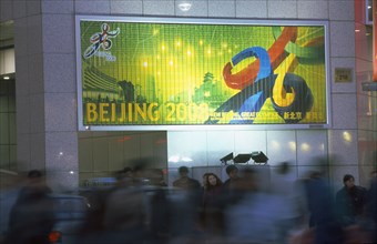 CHINA, Beijing, Busy street with poster advertising the 2008 Olympic Games to be held in Beijing.