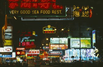 HONG KONG, Markets, Streets, Busy street with neon signs and advertising illuminated at night.
