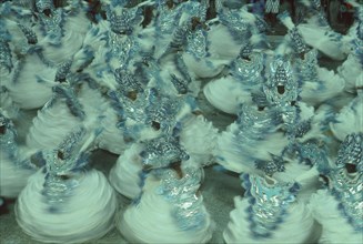 BRAZIL, Rio de Janeiro, Carnival procession crowd in blue and white costumes spinning around