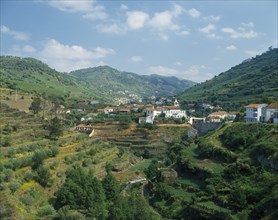 PORTUGAL, Douro Valley, Santa Marta, View over terraced hillside towards white painted village with