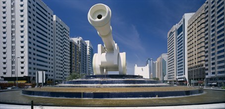UAE, Abu Dhabi, Al-Ittihad Square with huge sculpture of a cannon set on a circular tiered