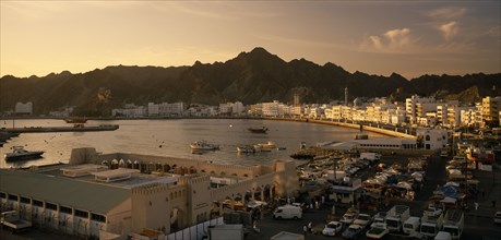 OMAN, Muscat, View of Mutrah area of Muscat including harbour and Mutrah Souk in the foreground.