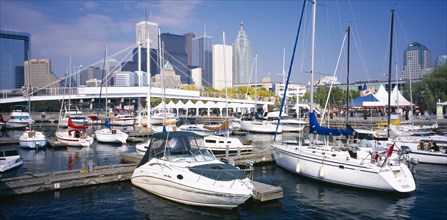 CANADA, Ontario, Toronto, Harbourfront Park.  View over moored boats towards city skyline behind.