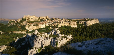 FRANCE, Provence-Cote d’Azur, Les Baux de Provence, View over rocky outcrop towards fortified hill