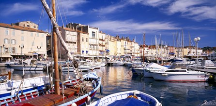 FRANCE, Provence-Cote d’Azur, St Tropez, View over harbour and moored boats towards waterside