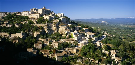 FRANCE, Provence-Cote d’Azur, Gordes, View over hill village and landscape beyond.  Vaucluse