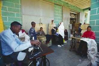 ETHIOPIA, Addis Ababa, "The Mercato, Africas largest market.  Group of men using hand powered