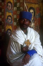 ETHIOPIA, Gonder Province, Gonder, "Church of Debre Birhan Selasie.  Portrait of priest in front of