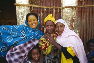 ETHIOPIA, Harerge Province, People, Group of young women with a child in colourful dress.