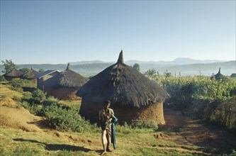 ETHIOPIA, Harerge Province, "Village near city of Harer.  Circular, thatched huts with villager