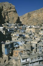 SYRIA, South, Maaloula, View over village set into eroded red stone cliff face.