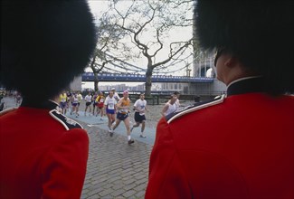 SPORT, Athletics, London Marathon, Runners and Tower Bridge seen between two Guardsmen both wearing