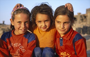 SYRIA, South, Bosra, Three smiling young girls.