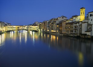 ITALY, Tuscany, Florence, View towards the Ponte Vecchio and waterside buildings at night with