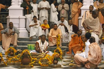 INDIA, Utter Pradesh, Vrindaven, Monks and worshippers on temple steps. Dirwali festival?