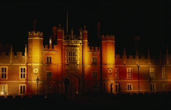 ENGLAND, London, Hampton Court, View of exterior facade illuminated at night.