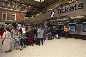 TRANSPORT, Rail, Stations, Passengers queue for tickets at London Victoria