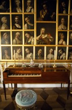 RUSSIA, St Petersburg, Peterhof, Great Palace.  Interior of state room with piano and portraits.