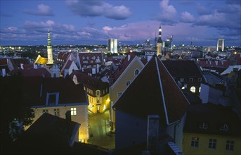 ESTONIA, Tallinn, View across Old Town rooftops at night.