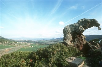 ITALY, Sardinia, Near Castelsardo. View of Elephant Rock in landscape over looking fields and hills